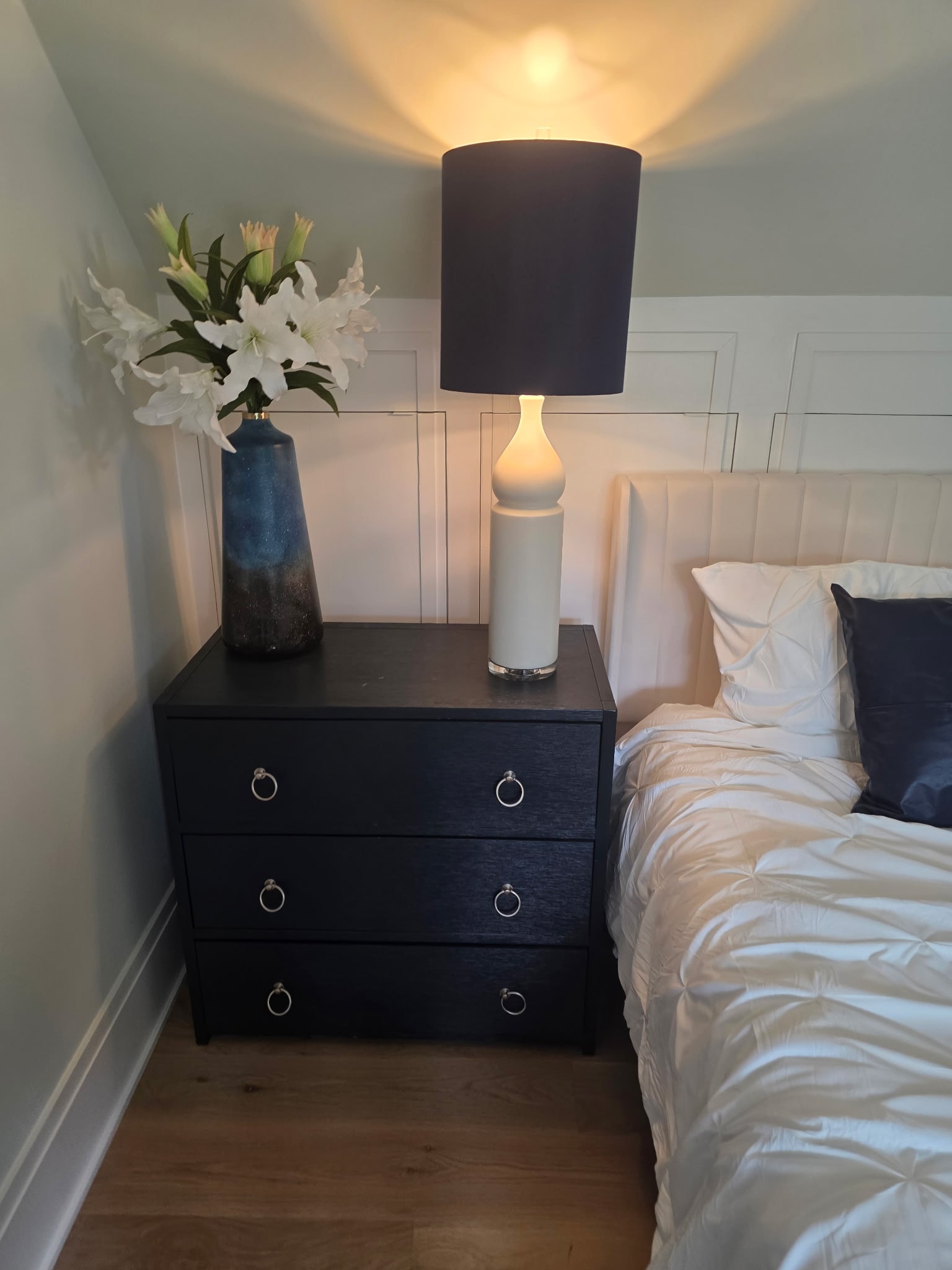 Twin bed with large gold-framed abstract canvas